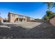 Expansive backyard featuring gravel landscaping and multiple fire pits, ideal for gatherings at 15611 W Cameron Dr, Surprise, AZ 85379