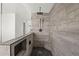 Contemporary bathroom featuring a glass shower, pebble flooring, and wood-look tile with a built-in bench at 15611 W Cameron Dr, Surprise, AZ 85379