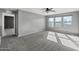 Spacious bedroom features ample natural light, neutral paint, and plush carpet at 15611 W Cameron Dr, Surprise, AZ 85379