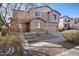 Charming two-story home with a well-manicured lawn and inviting curb appeal at 15611 W Cameron Dr, Surprise, AZ 85379