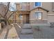 Inviting front entrance with a stone accent wall and brick walkway at 15611 W Cameron Dr, Surprise, AZ 85379