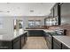 Bright, updated kitchen features black cabinets, stainless appliances, and a center island at 15611 W Cameron Dr, Surprise, AZ 85379