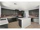 Updated kitchen with black cabinets, white countertops, stainless steel appliances, and modern backsplash at 15611 W Cameron Dr, Surprise, AZ 85379