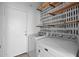Well-organized laundry room with shelving and a modern washer and dryer at 15611 W Cameron Dr, Surprise, AZ 85379