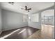 Spacious living room with natural light, ceiling fan, and vinyl wood flooring at 15611 W Cameron Dr, Surprise, AZ 85379