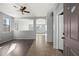 Bright, open-concept living area with wood and tile flooring and arched doorways at 15611 W Cameron Dr, Surprise, AZ 85379