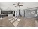 Open-concept living space flows from updated kitchen to a bright living area with stairs at 15611 W Cameron Dr, Surprise, AZ 85379