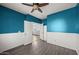 Office space featuring elegant blue walls, stylish wood-look floors, and French doors at 15611 W Cameron Dr, Surprise, AZ 85379