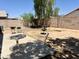 Spacious backyard with multiple seating areas and mature trees, perfect for outdoor entertaining at 15706 W Young St, Surprise, AZ 85374