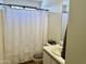Bright, neutral bathroom with a shower curtain and a vanity with a sink at 15706 W Young St, Surprise, AZ 85374