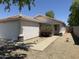 Welcoming single-level home featuring a two-car garage, desert landscaping and a cozy entryway at 15706 W Young St, Surprise, AZ 85374