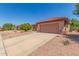 Lovely single-story home with a well-manicured desert landscape and attached two-car garage at 15980 W Quail Creek Ln, Surprise, AZ 85374
