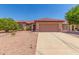 Charming single-story home featuring a terracotta-tiled roof and a desert-landscaped front yard at 15980 W Quail Creek Ln, Surprise, AZ 85374