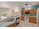 Open kitchen features tile flooring, stainless steel appliances, wood cabinets, and great natural lighting at 15980 W Quail Creek Ln, Surprise, AZ 85374
