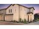 Charming two-story home with a two-car garage, desert landscaping, and a warm, inviting facade at 16456 W Whispering Wind Dr, Surprise, AZ 85387