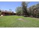 Expansive backyard with lush green lawn and mature trees at 1844 W Virginia Ave, Phoenix, AZ 85007