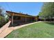 Backyard view of a home, landscaped yard, and covered patio at 1844 W Virginia Ave, Phoenix, AZ 85007