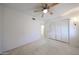 Bright bedroom with neutral carpet, ceiling fan, and ample closet space at 1844 W Virginia Ave, Phoenix, AZ 85007