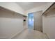 Spacious walk-in closet featuring shelves, rods, and access to bedroom via sliding door at 1844 W Virginia Ave, Phoenix, AZ 85007
