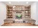 Unique stone fireplace featuring built-in shelving and comfortable seating areas at 1844 W Virginia Ave, Phoenix, AZ 85007
