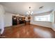 View of kitchen with black appliances, stone tile flooring, and a breakfast bar island at 1844 W Virginia Ave, Phoenix, AZ 85007