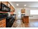 Well-lit kitchen with black appliances, wood cabinets, and a cozy breakfast bar at 1844 W Virginia Ave, Phoenix, AZ 85007