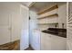 Convenient laundry room with washer, dryer, and storage shelves at 1844 W Virginia Ave, Phoenix, AZ 85007