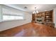 Inviting living room featuring hardwood floors and a stone fireplace with built-in shelving at 1844 W Virginia Ave, Phoenix, AZ 85007