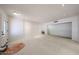 Spacious living room featuring light-colored carpeting, a glass door, and recessed lighting at 1844 W Virginia Ave, Phoenix, AZ 85007