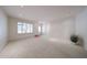 Bright and airy living room with neutral carpeting, complemented by natural light from the window at 1844 W Virginia Ave, Phoenix, AZ 85007