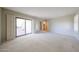 Bright living room with neutral carpet, large sliding doors, and natural light at 1844 W Virginia Ave, Phoenix, AZ 85007