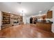 Open-concept living area featuring a stone fireplace, hardwood flooring, and a modern kitchen at 1844 W Virginia Ave, Phoenix, AZ 85007