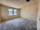 Under construction bedroom with two large windows and unfinished walls and floors at 18751 W Monterosa St, Litchfield Park, AZ 85340