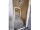Under construction view of a hallway with an arched doorway and unfinished walls and floors at 18751 W Monterosa St, Litchfield Park, AZ 85340