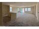 Unfinished large living room with multiple windows and sliding glass door leading to the backyard at 18751 W Monterosa St, Litchfield Park, AZ 85340