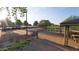 Park scene featuring a basketball court, a covered picnic area, and lush landscaping on a bright day at 18751 W Monterosa St, Litchfield Park, AZ 85340