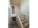 View of unfinished staircase under construction with safety railing, unfinished walls and floors at 18751 W Monterosa St, Litchfield Park, AZ 85340