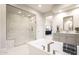 Bright bathroom with a sleek freestanding tub, glass-enclosed shower with patterned tile, and double vanity at 22673 E San Tan Blvd, Queen Creek, AZ 85142