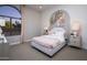 Bedroom with neutral carpet, a large arched window, and whimsical decorations at 22673 E San Tan Blvd, Queen Creek, AZ 85142