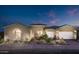 Stunning exterior of home features a two-car garage and lush landscaping creating excellent curb appeal at 22673 E San Tan Blvd, Queen Creek, AZ 85142