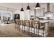 Open kitchen with a large island, seating, stainless steel appliances, and easy access to the dining area at 22673 E San Tan Blvd, Queen Creek, AZ 85142