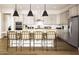 Bright kitchen featuring stainless steel appliances, quartz countertops, and a large center island with seating at 22673 E San Tan Blvd, Queen Creek, AZ 85142