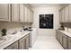 Well-lit laundry room with ample storage cabinets, modern washer and dryer, and stylish countertops at 22673 E San Tan Blvd, Queen Creek, AZ 85142