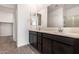 Modern bathroom with double sink vanity and large mirror at 31476 N Hayweather Ln, San Tan Valley, AZ 85143