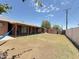 Large backyard with covered patio, block fence, storage shed, and well maintained desert landscaping at 3937 W Stella Ln, Phoenix, AZ 85019