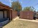 A spacious backyard featuring two storage sheds. One has closed doors; the other has a door missing at 3937 W Stella Ln, Phoenix, AZ 85019