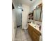 This is a bathroom with tile floors, a toilet, a sink, a mirror, and a shower stall at 3937 W Stella Ln, Phoenix, AZ 85019
