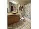 Functional bathroom featuring a vanity with a vessel sink, complemented by a shower and bathtub combination at 3937 W Stella Ln, Phoenix, AZ 85019