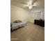 Cozy bedroom with tile flooring, a ceiling fan, and natural light, providing a comfortable and relaxing space at 3937 W Stella Ln, Phoenix, AZ 85019