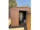 The shed has a open door, exposing the disorganized storage space inside at 3937 W Stella Ln, Phoenix, AZ 85019